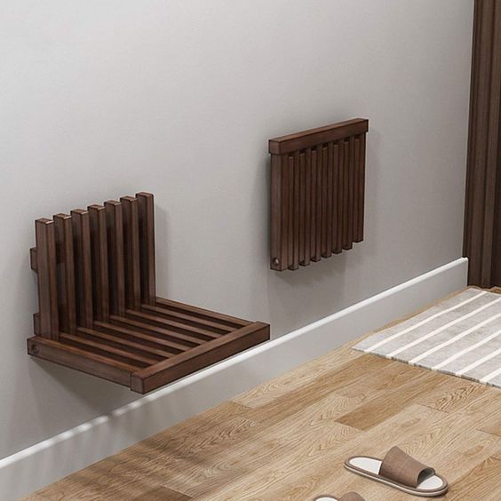 Image of two folding wooden wall mounted seats; one folded and one opened.