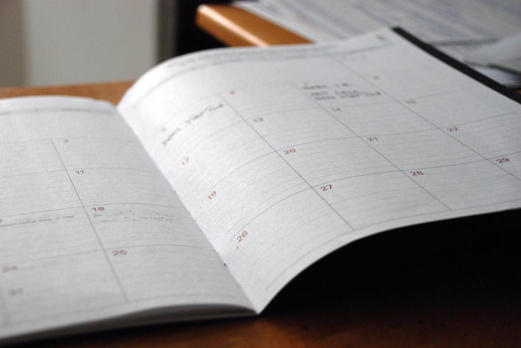 Image of open calendar day planner page with illegible notes.
