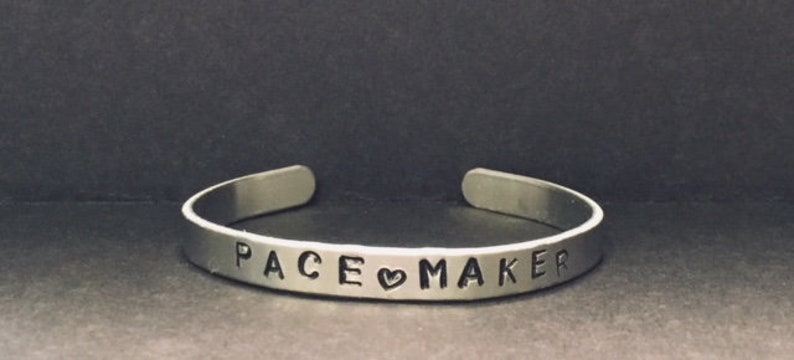 Image depicts customizable stamped medical alert bangle bracelet, and links to Etsy seller.