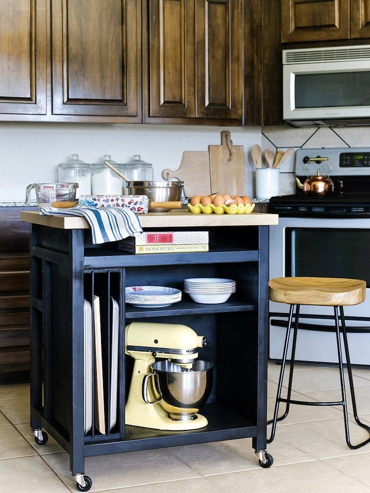 Image shows small portable kitchen island on wheels, and links to Bob Vila site.