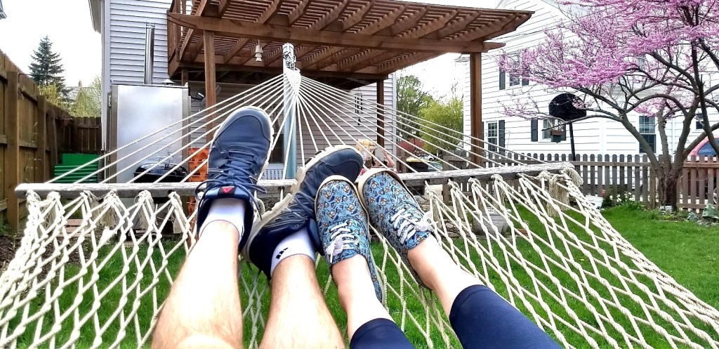 Image of the feet of two people in a hammock. 