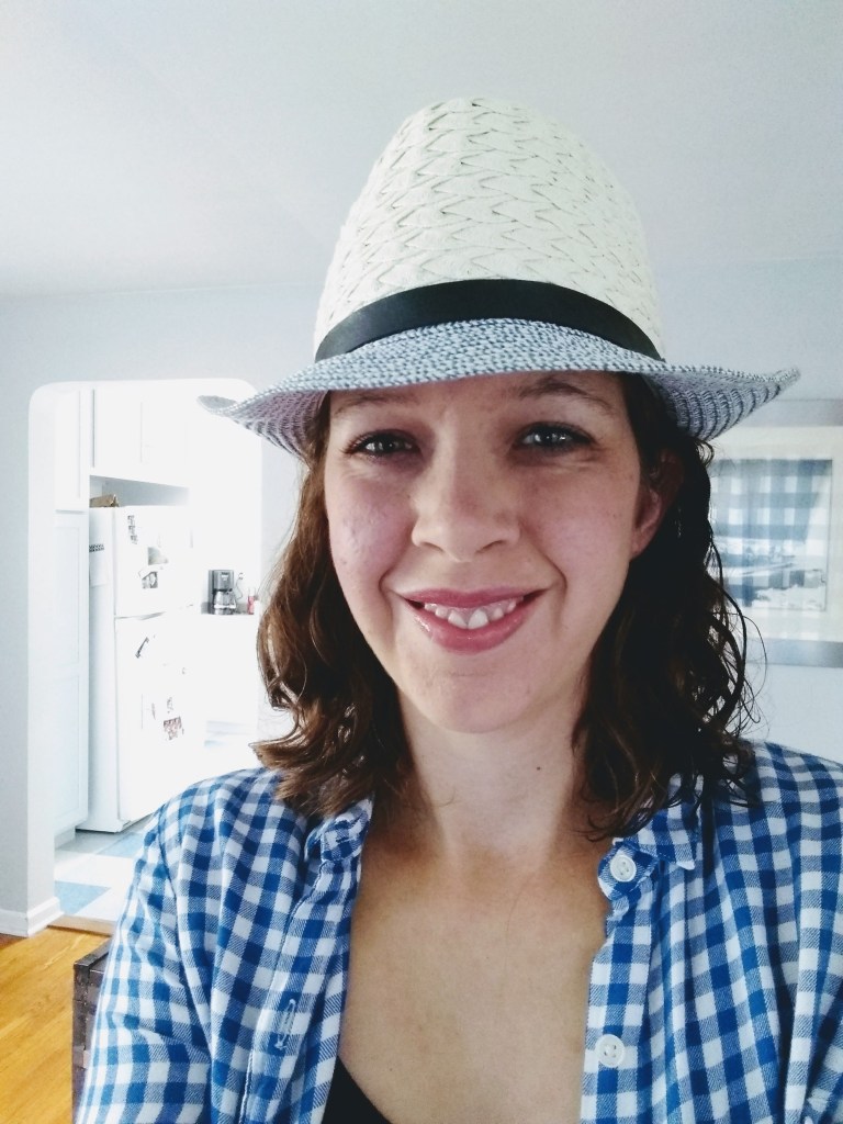 Image of the author wearing a straw fedora. 
