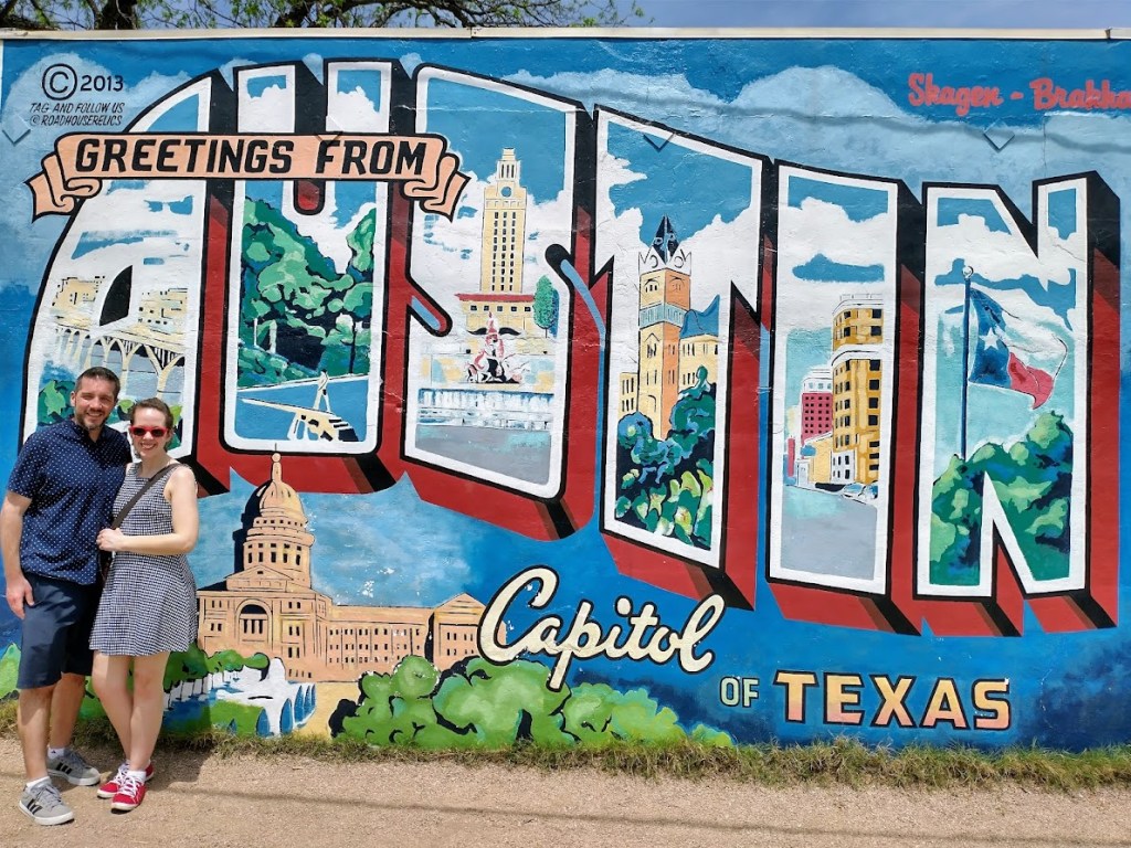 The author and her husband pose in front of an Austin mural, by Livable by Design
