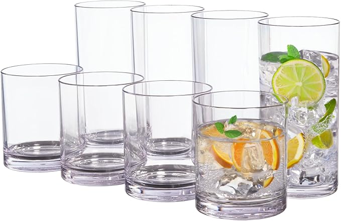 A set of eight clear acrylic, cylindrical glasses. Four are tall, four are tumbler-sized. The closest two glasses in each size contain ice cubes and slices of citrus fruits.