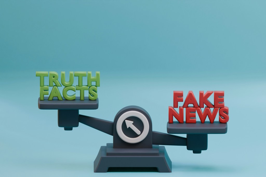 A graphic image of a gray scale with "Truth Facts" in green on the left side of the scale, shown higher than the right, and "Fake News" in red on the right side.
